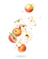 Whole and sliced fresh apples in the air, isolated on a white background