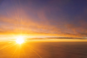 Fototapeta na wymiar the sea of cloud sunset sky background from window airplane