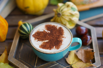 Cup of coffee with cinnamon on an open table