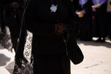 A "manola" is holding a rosary, Holy Week