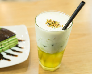Tasty matcha cake with cold tea for dessert in a Korean restaurant.