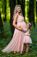 Fototapeta premium Pregnant woman and her daughter