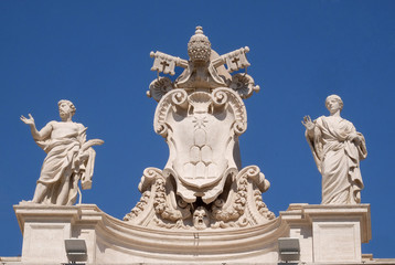 Fototapeta na wymiar St. Vitalis, Alexander VII Coat of Arms, St. Petronilla, fragment of colonnade of St. Peters Basilica. Papal Basilica of St. Peter in Vatican, Rome, Italy 