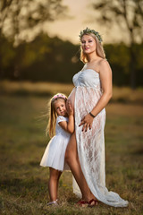 Fototapeta na wymiar Pregnant woman and her daughter