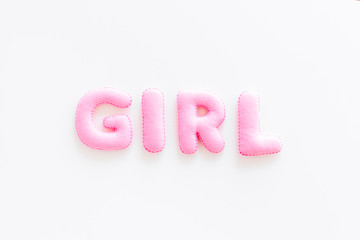 Girl word as decoration for baby shower on white background top view copy space