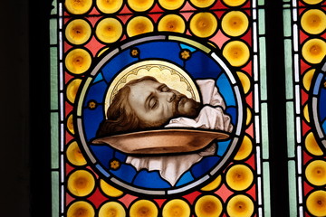 The head of Saint John the Baptist, stained glass window in Basilica of Saint Sylvester the First (San Silvestro in Capite) in Rome, Italy 