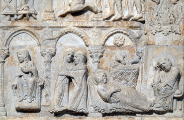 Annunciation, Visitation and Birth of Jesus, medieval relief on the facade of Basilica of San Zeno in Verona, Italy
