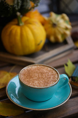 Cup of coffee with cinnamon on an open table