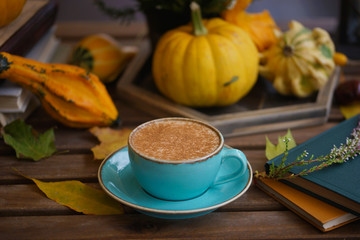 Cup of coffee with cinnamon on an open table