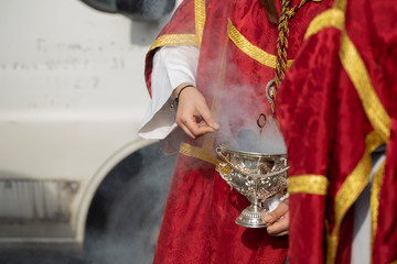 Child holding a censer in a procession, Holy Week