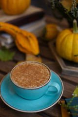 Cup of coffee with cinnamon on an open table