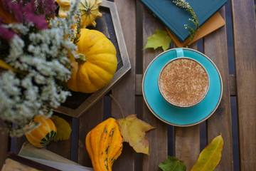 Cup of coffee with cinnamon on an open table