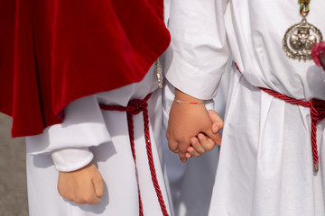 Interlaced hands in a procession, Holy Week	