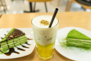 Tasty matcha cake with cold tea for dessert in a Korean restaurant.