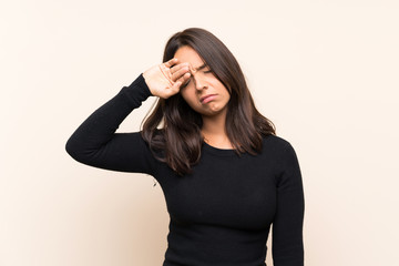 Young brunette woman with white sweater over isolated background with tired and sick expression