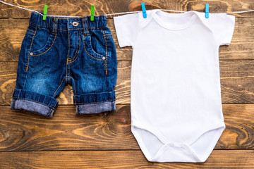 Mockup of white baby bodysuit shirt and jeans