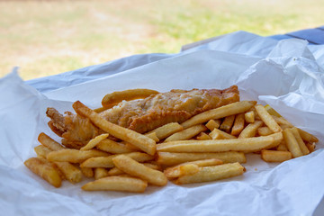 Beer battered Barramundi fish and chips  in traditional paper wrapping