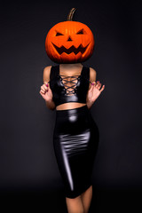 Halloween sexy model with a pumpkin on her head. Beautiful young woman in sexy lingerie. Wide Halloween party design - picture