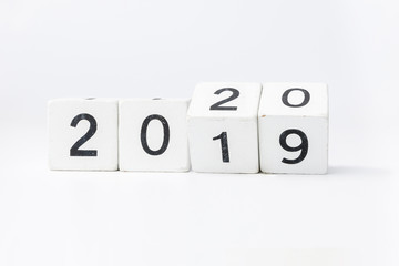 Business and design concept - geometric floating wooden cube on white background. 2019 2020 years.