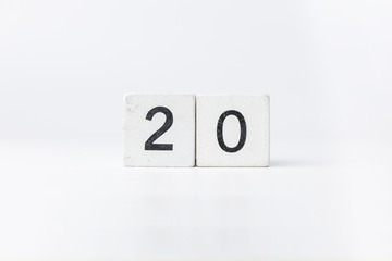 Business and design concept - geometric floating wooden cube on white background. 2020 years.