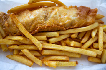 Beer battered Barramundi fish and chips  in traditional paper wrapping