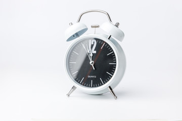 Vintage black-white alarm clock on a white background. midnight