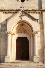 Fototapeta na wymiar Entrance portal of the Church of Blessed Virgin of Purification in Smokvica, Korcula island, Croatia