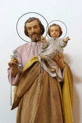 Saint Joseph holding child Jesus, statue on the altar in the Church of Blessed Virgin of...