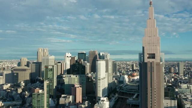 day orbiting counter clockwise around top of DTT Docomo Yoyogi building in Shinjuku Tokyo