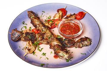 Kebab with garnish and sauce