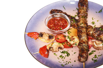 Kebab with garnish and sauce