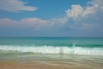 Fototapeta na wymiar Blue skies beautiful white waves at Karon beach in phuket