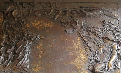 The Annunciation, detail on the door of the church of St. James the Greater in Porto Azzurro, Elba, Italy
