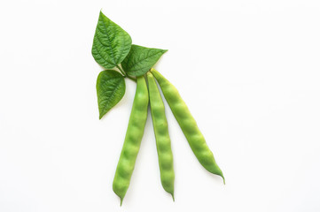 Isolated fresh green bean pods with green leaves. Top view.