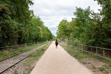 Fototapeta premium Paris, France: People walking on the old railways ring of the Petite Ceinture, transformed as a promenade area.