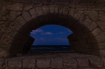 Night  view of the remains of an ancient Roman aqueduct located near Caesarea in Israel