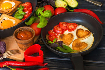 fried eggs heart-shaped breakfast on a black background