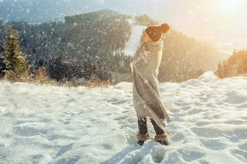 Happy woman traveler on the snowy of mountain look on the nice w