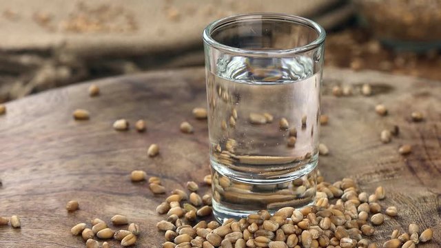 Wheat Liqueur shot on a rotating vintage plate as seamless loopable 4K UHD footage