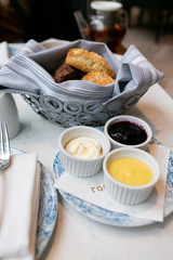 Scones at high tea with mascarpone, lemon curd, and jam