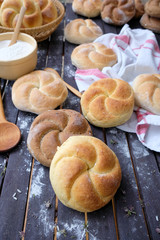 Kaiser rolls on a wooden table closeup