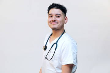 Portrait of a young hispanic male healthcare professional, portrait of a medical intern