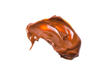 Melted tasty caramel splashes isolated on white background.