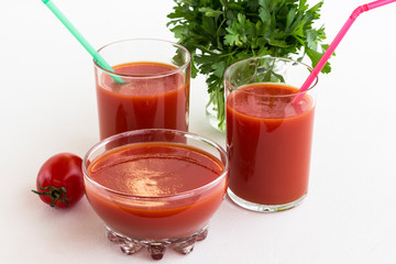 Tomato juice, tomato, bunch of green parsley on a white background