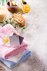 Eco-friendly bath set with brushes, sea salt, towel, aroma in glass bottle , bast and leafs on a...