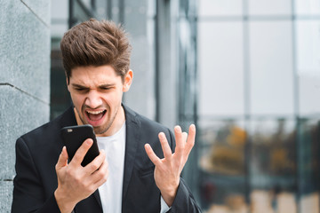 Businessman screaming on mobile phone. Having nervous breakdown at work, screaming in anger, stress...