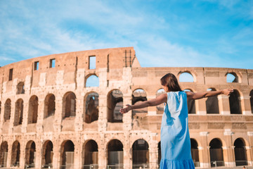 Young female tourist looking at the Colosseum outside in Rome, Italy.