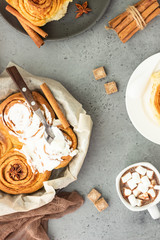 Cinnamon rolls (Cinnabon) on a plate with hot chocolate or cocoa drink. Kanelbullens dag.