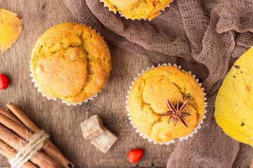 Sweet pumpkin or carrot muffins with fall spices. Autumn dessert. Healthy baking concept. Copy space.