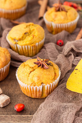 Sweet pumpkin or carrot muffins with fall spices. Autumn dessert. Healthy baking concept. Copy space.
